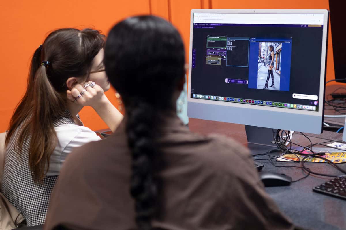 Students reviewing a ComfyUI workflow on a monitor